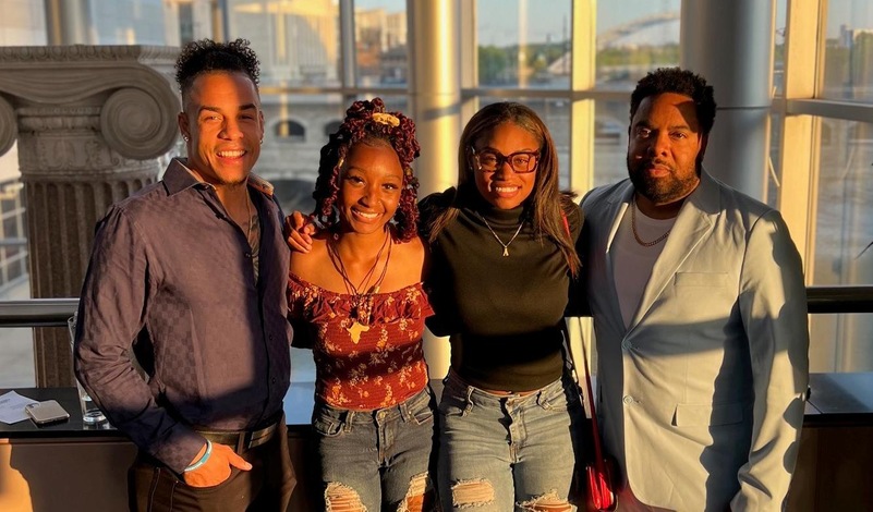 Mariah Brooks (L) and Ahnia Cherry (R) enjoy time at the NCAA Track & Field banquet with assistant coach Chris Belcher (L) and head coach Bill Dunn (R).